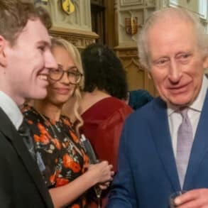 Elliott shakes hands with King Charles at the Windsor Castle reception