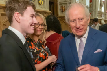 Elliott shakes hands with King Charles at the Windsor Castle reception