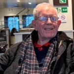 Geoff Winch sitting in waiting area at hospitalome