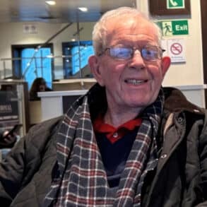 Geoff Winch sitting in waiting area at hospitalome