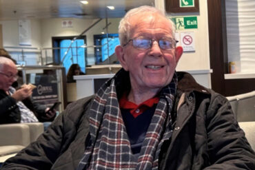 Geoff Winch sitting in waiting area at hospitalome