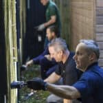 People painting a fence