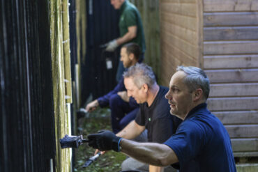 People painting a fence