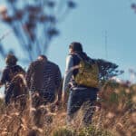 Low down shot of in a field of people walking past