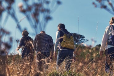Low down shot of in a field of people walking past
