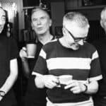 Black and white photo of band members of The Loft standing in a doorway