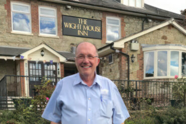 Tony Russell - aka Mr Mouse - standing in the garden of the Wight Mouse Inn pub