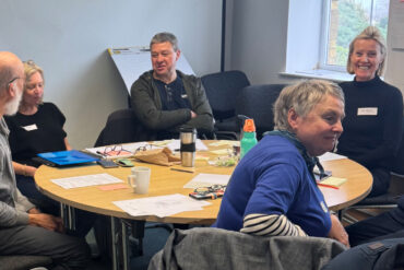 People sitting around a table during the Winter Gardens Workshop
