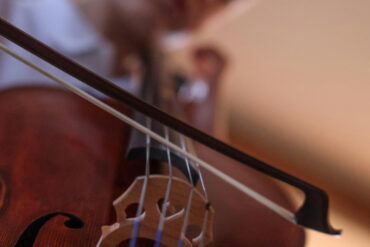 a young boy playing the violin