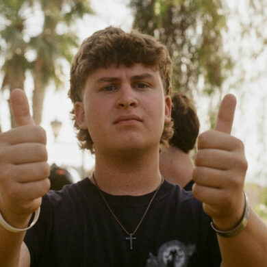 Older male teen gives a double thumbs up