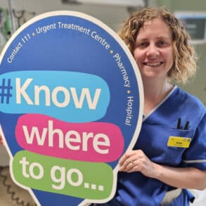 nurse holding 'know where to go' sign