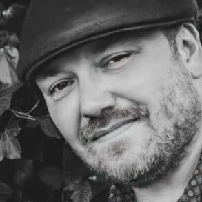 Black and white photo of Ben Allman with his guitar