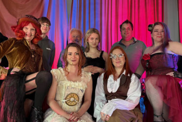 Time Nor Tide CIC players in costume posing on stage