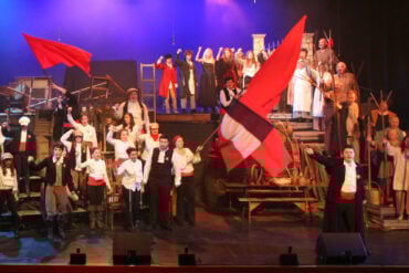 Children on stage performing Les Miserables