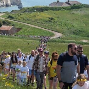 Long line of walkers walking up the Tennyson Downs