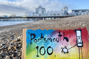 My Dog Sighs painting on the beach by the pier