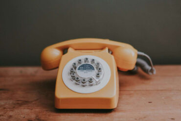 Orange telephone on a table