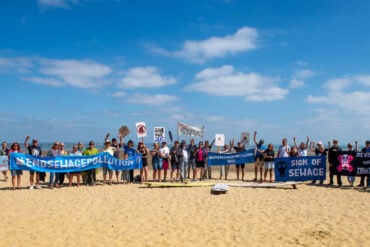 People at the Paddle Out Protest on Appley Beach in May 2025