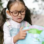 child looking at a globe