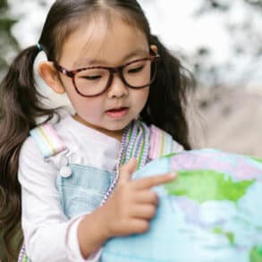child looking at a globe