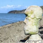 hideous head sculpture on Bouldnor Beach