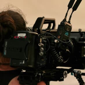 woman with film camera on her shoulders