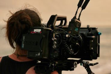 woman with film camera on her shoulders