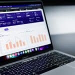 Computer laptop with balance sheet graphs on it