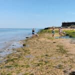Parents and children playing on Fort Vic beach