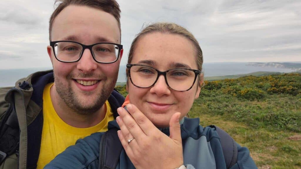 The engaged couple showing their ring