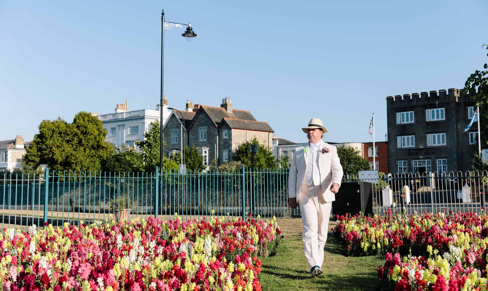 Actor playing Oscar Wilde walking through public gardens in Ryde