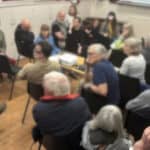 people attending the emergency climate briefing screening blurred background