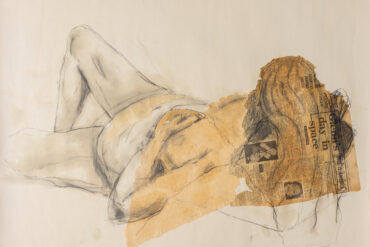 Nude life drawing of woman laying on bed
