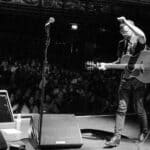 tom bright performimg on stage in front of a large audience
