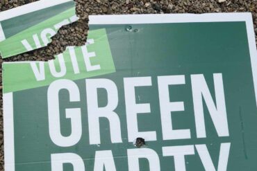 vandalised green party sign