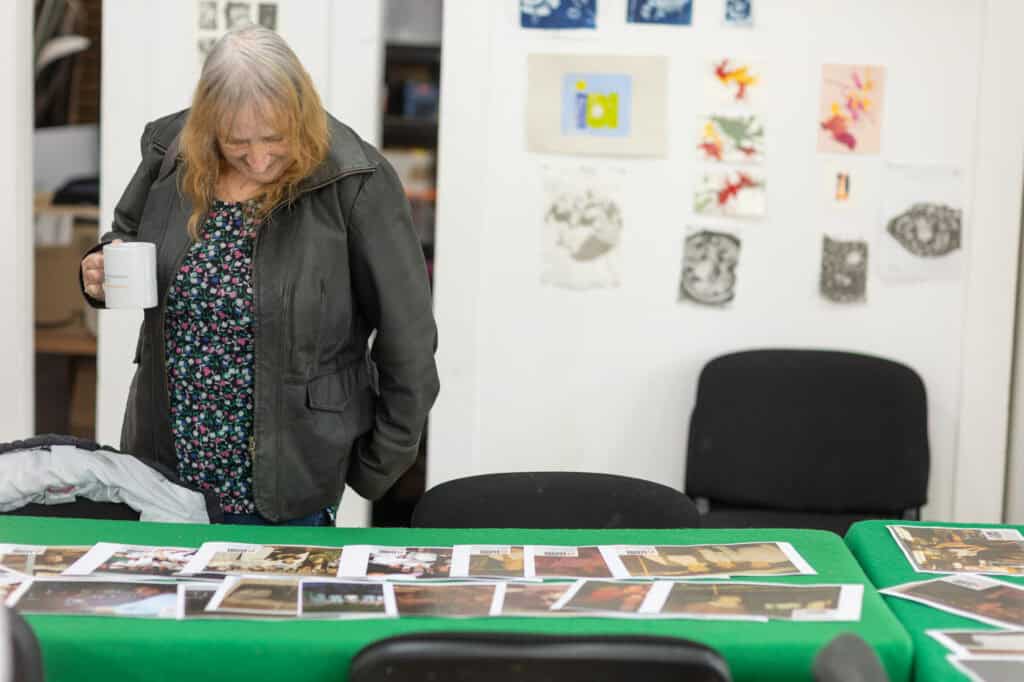 A person looking at photos at the Ronson Reunited event