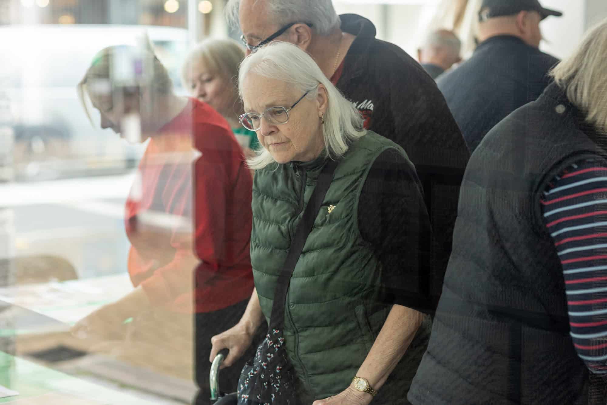People looking at photos at the Ronson Reunited event