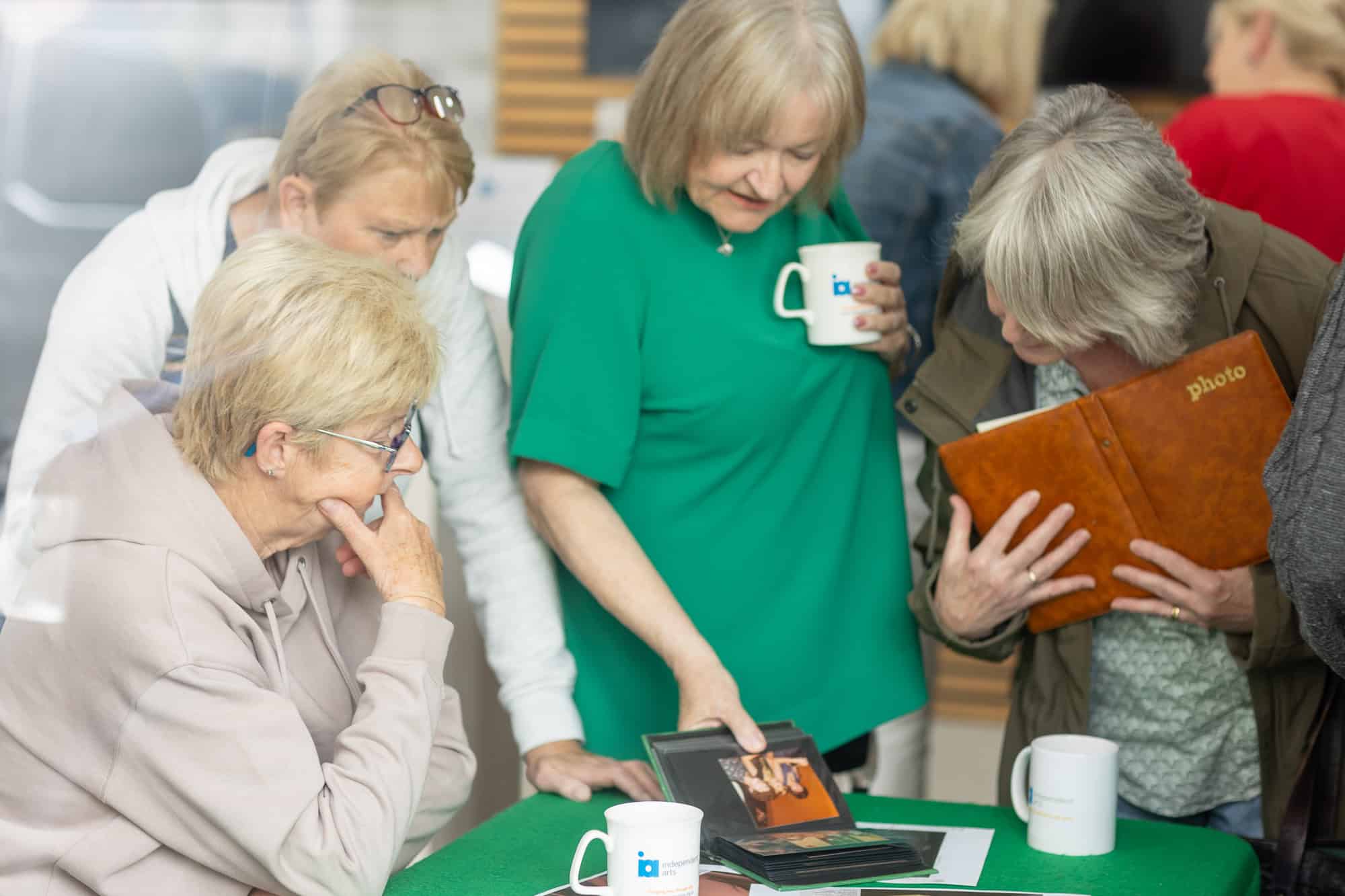 People looking at photos at the Ronson Reunited event