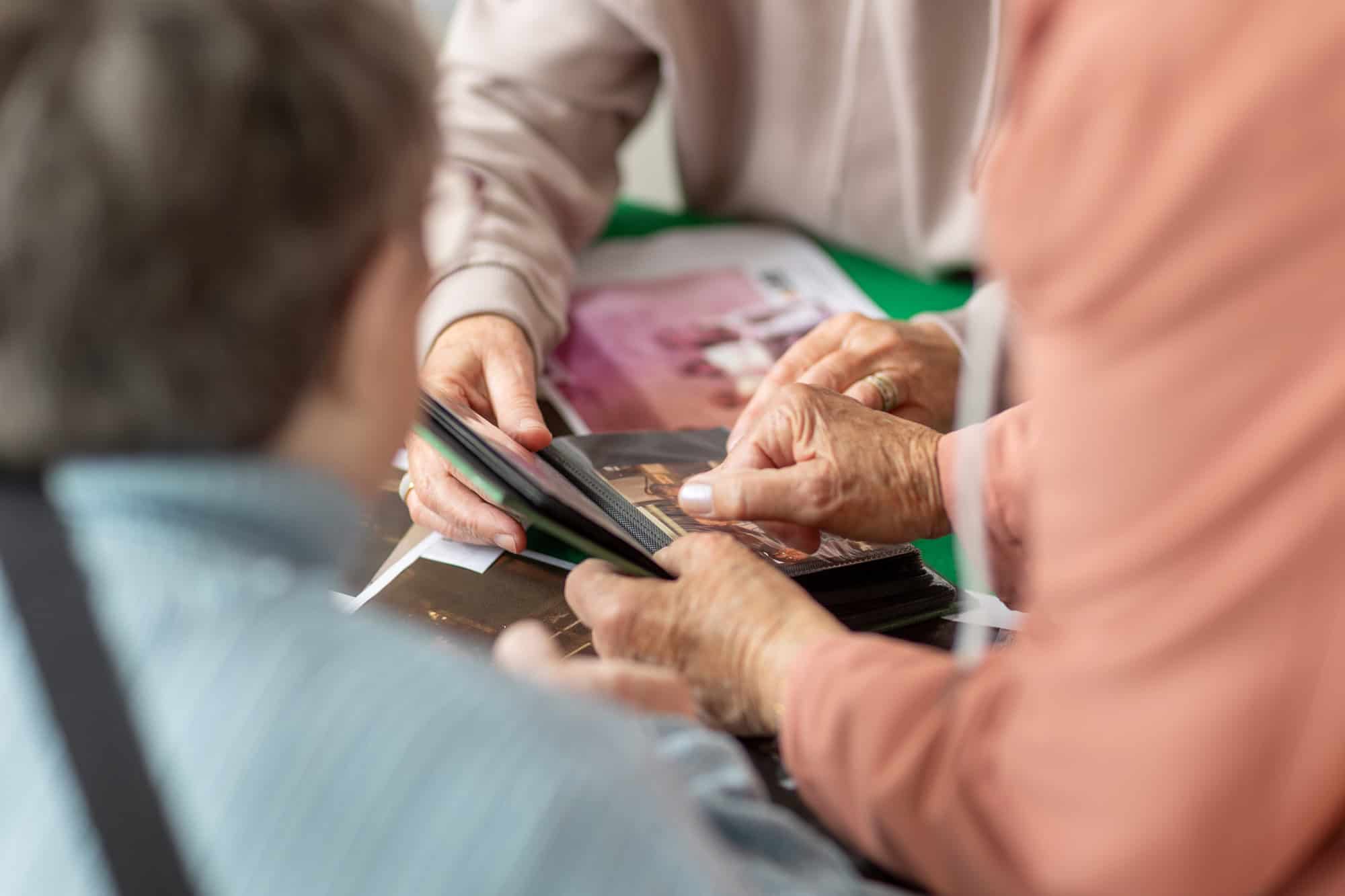 People looking at photos at the Ronson Reunited event
