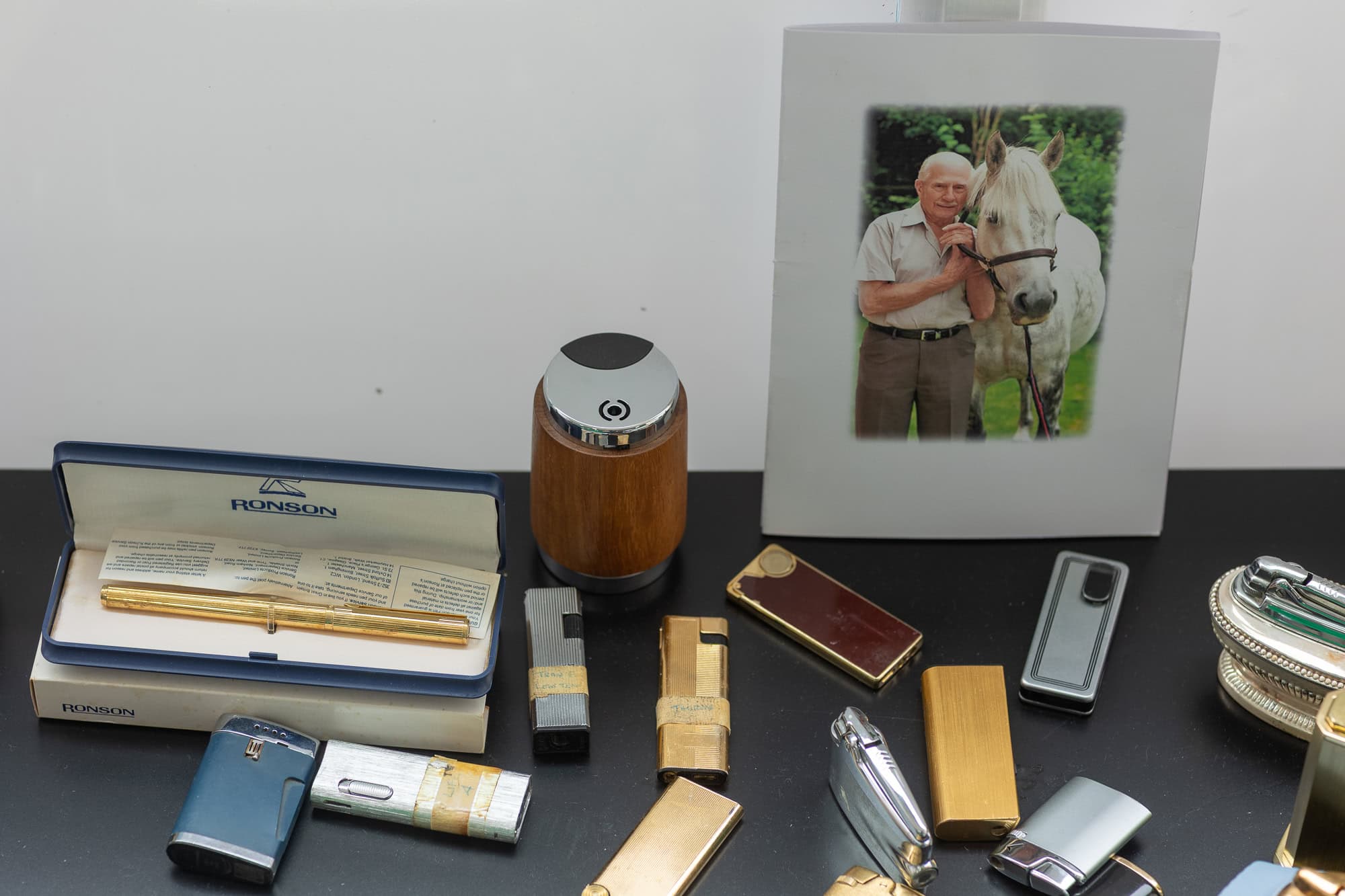 A selection of Ronson lighters, plus a pen and a photo of Stanley Whittington