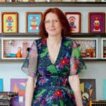 Fran Heath sitting on her desk surrounded by her dire-ramas and vintage typewriters