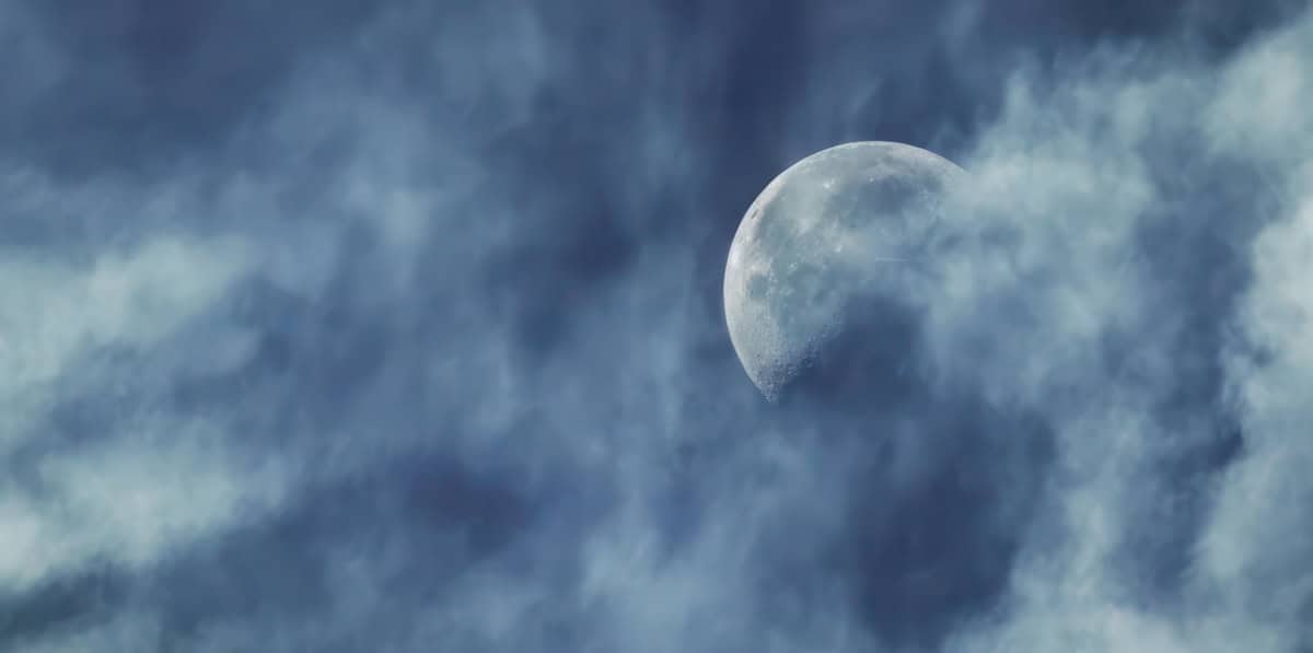 Moon against a blue sky with light clouds