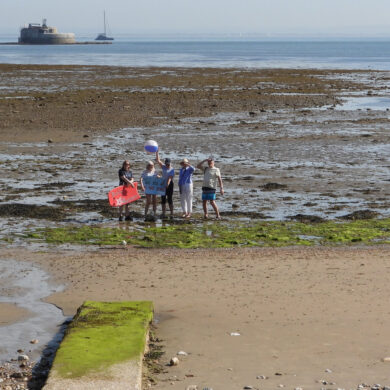 Distance shot of No Poo at the Point campaigners standing where the pipe will come out