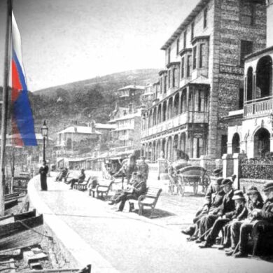 Old photo of Victorians sitting on Ventnor seafront with Russian flag hoisted