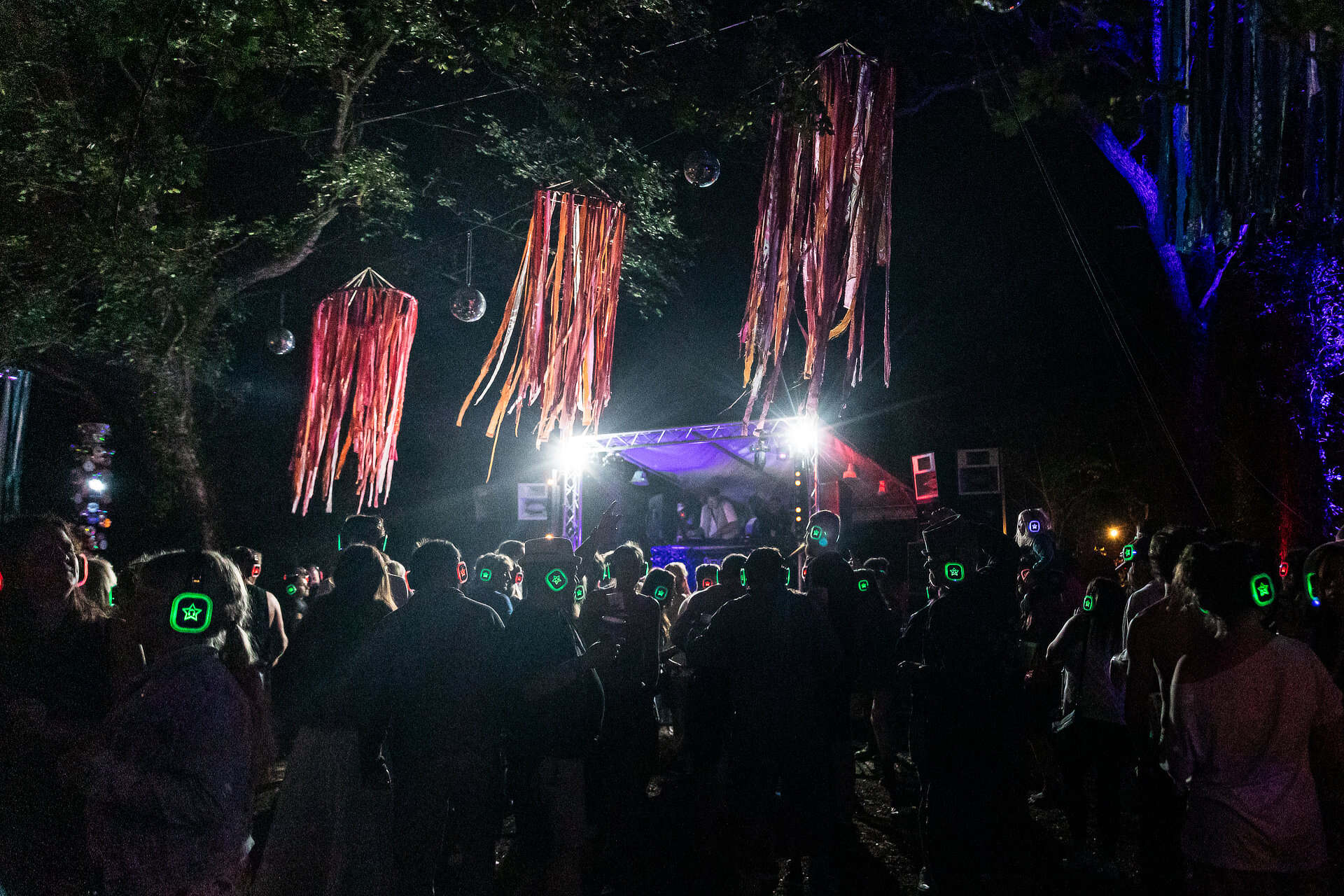People dancing at the Silent Disco in the woodland