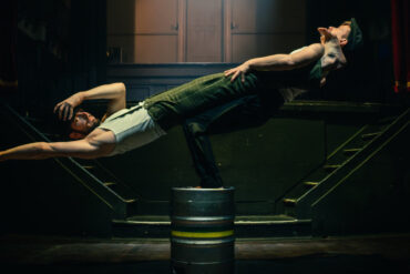 Two acrobats performing on stage
