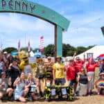 charity members posing for photo at Penny Lane site in Isle of Wight Festival