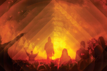 Silhouette shot of people in front of the Glastonbury pyramid stage