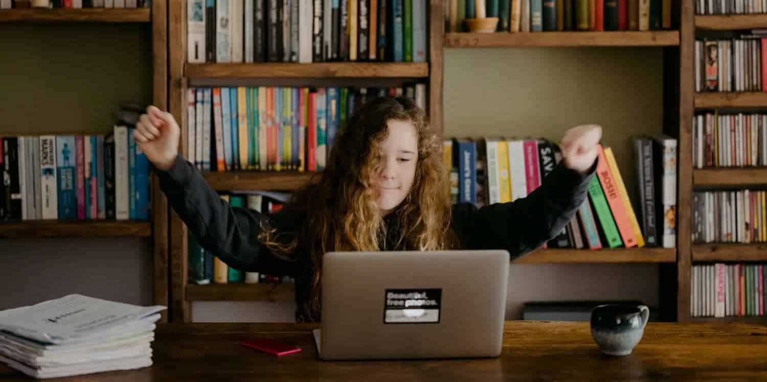 home educated girl working at table with computer by Annie Spratt