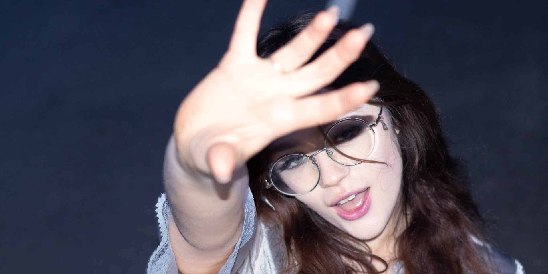 Maisy Dean holding her hand up to the camera
